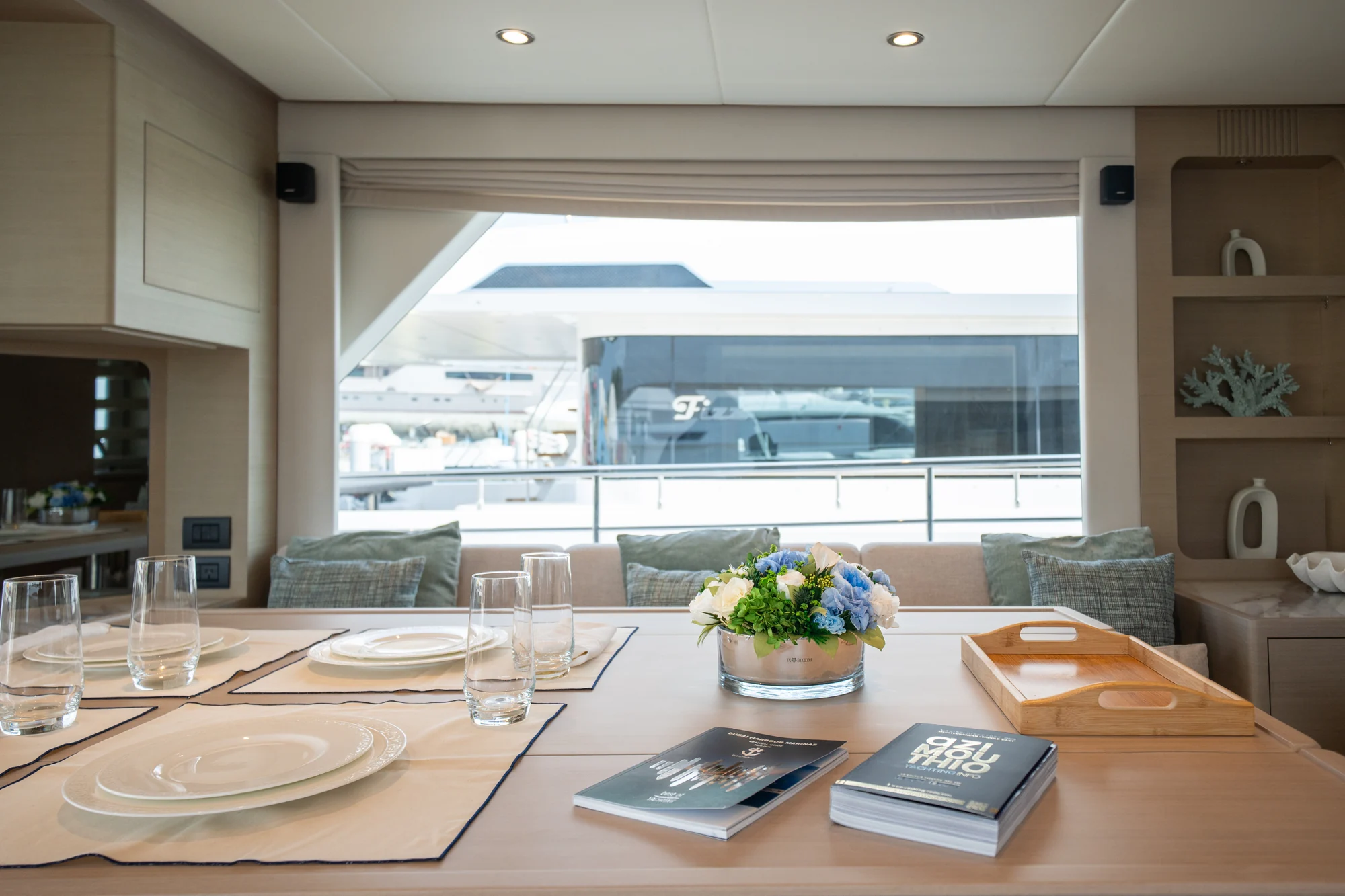 Blue and white IN BLOOM flowers on a yacht dining table