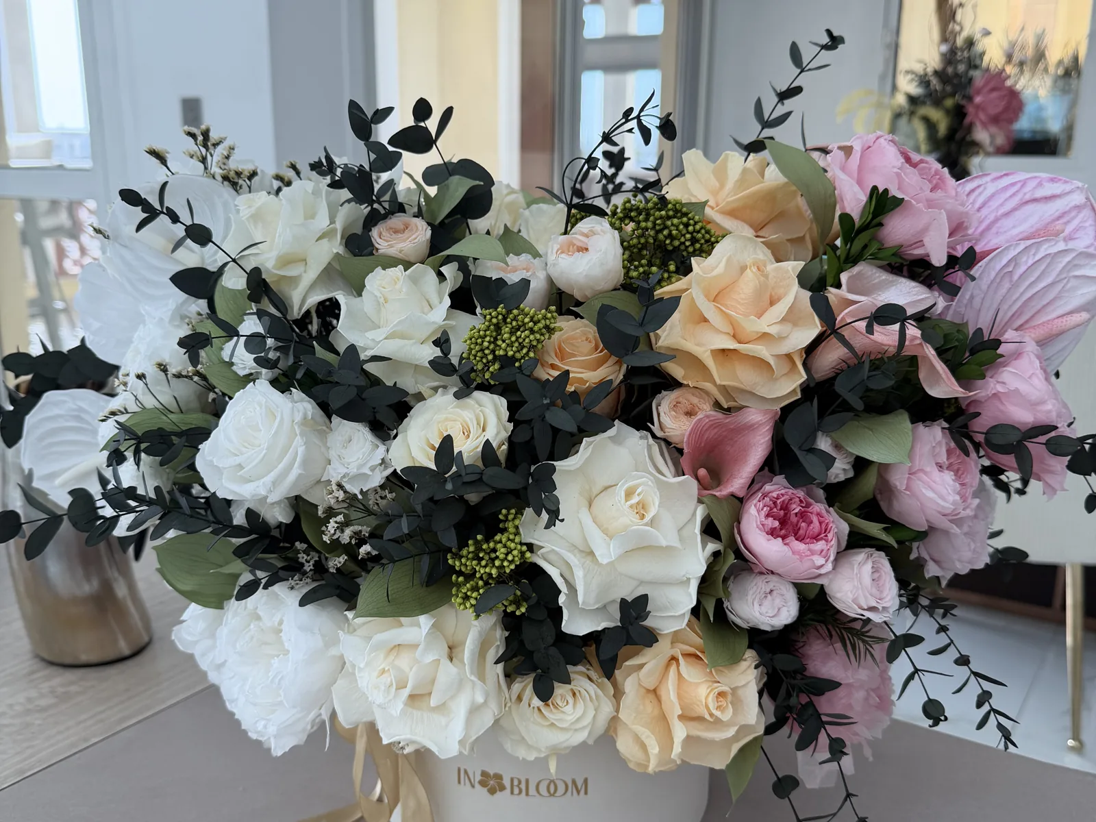 IN BLOOM arrangement of cream and pink flowers in a white box