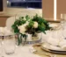 White and green preserved flower table centerpiece for a hospitality dining setting in Dubai